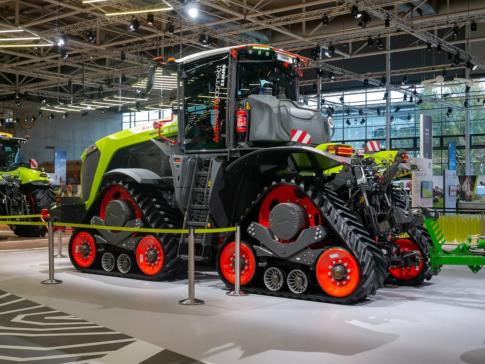 A tracked Claas tractor on display in an exhibition hall at Agritechnica 2023