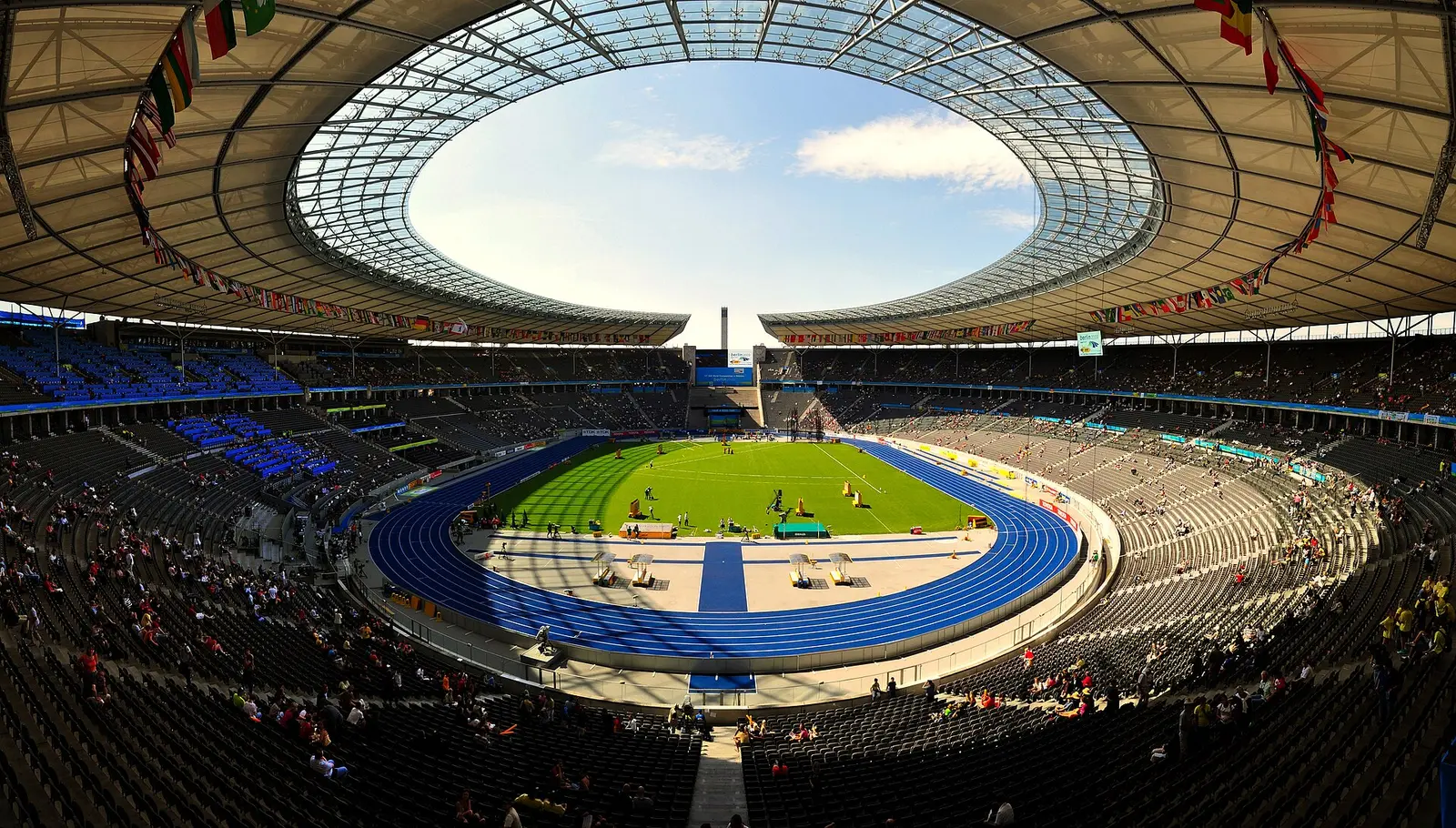 Interior of the Olympiastadion in Berlin with the blue athletics track and roof ring