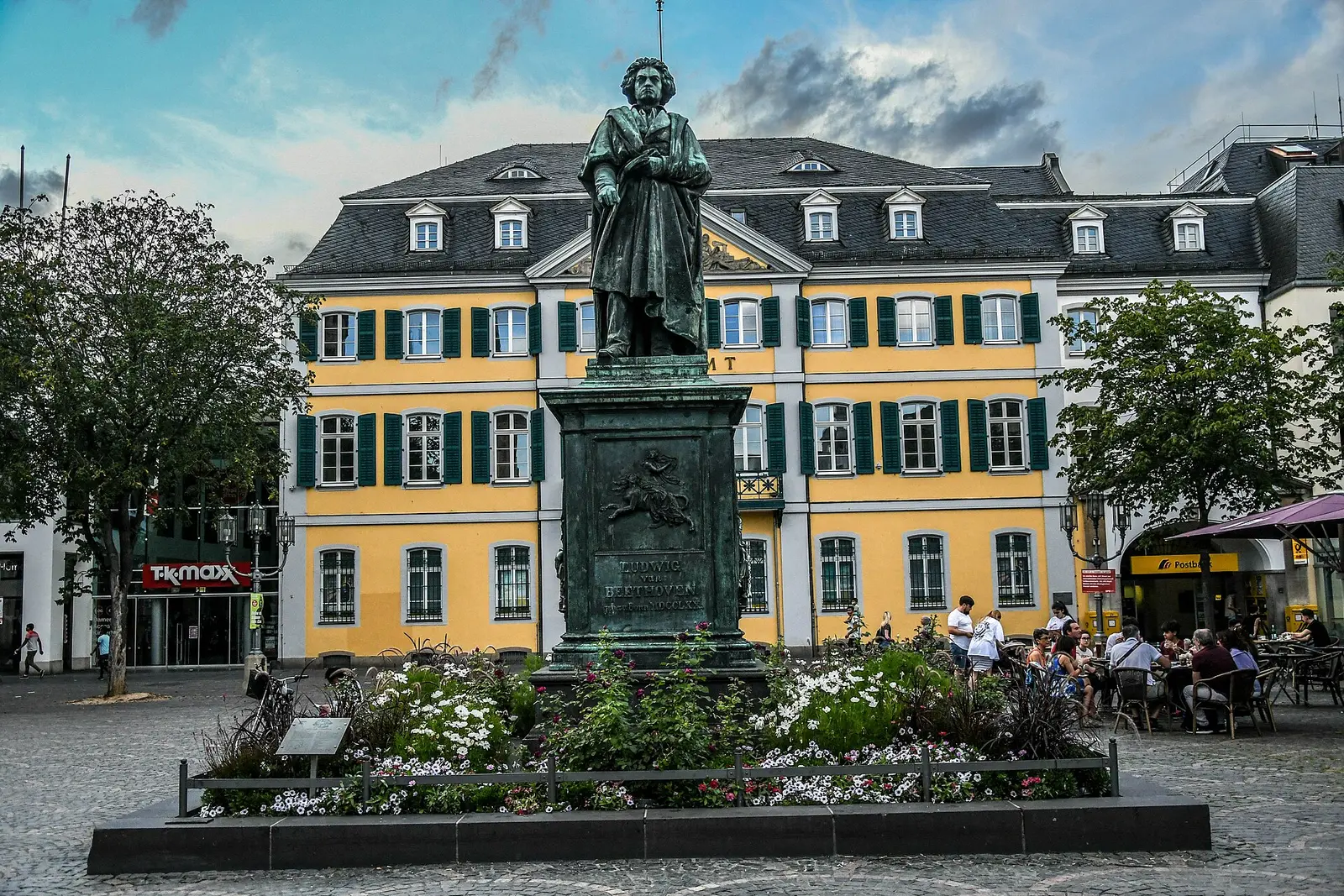 The Beethoven monument on Münsterplatz in Bonn in front of the yellow former post office building