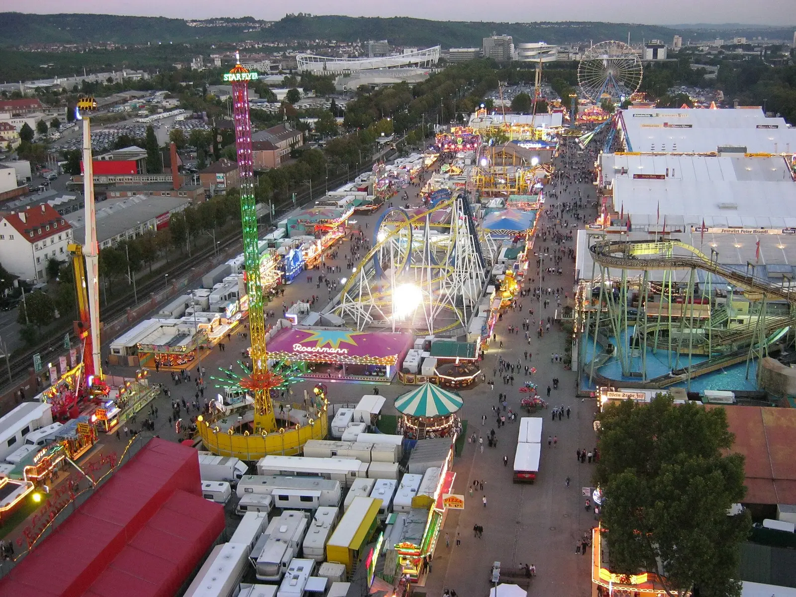 Aerial view of the lit rides, tents and crowds at the Cannstatter Volksfest in Stuttgart in 2012
