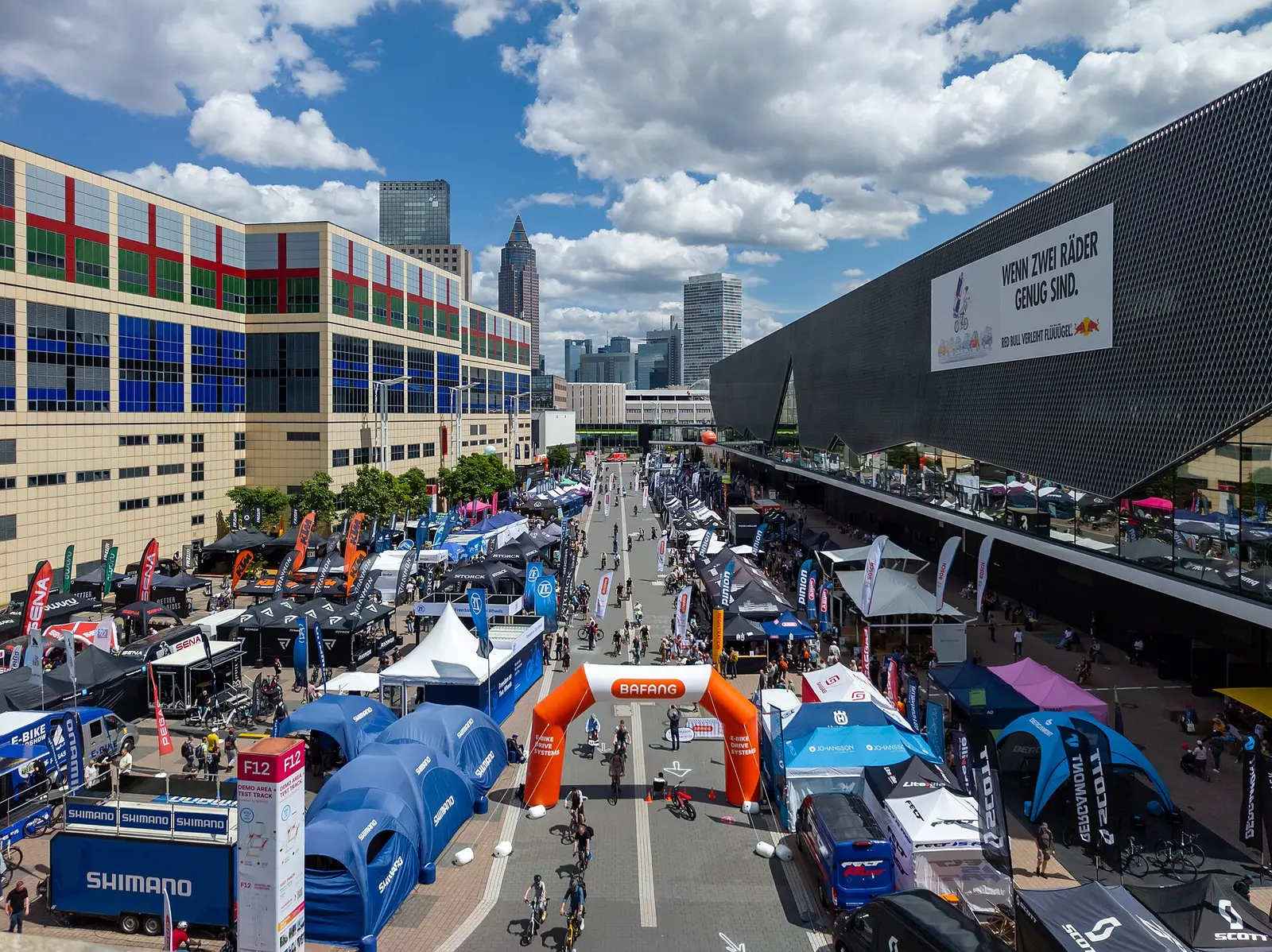 Visitors on the outdoor test track between tents at Eurobike 2024 beside the Frankfurt exhibition halls