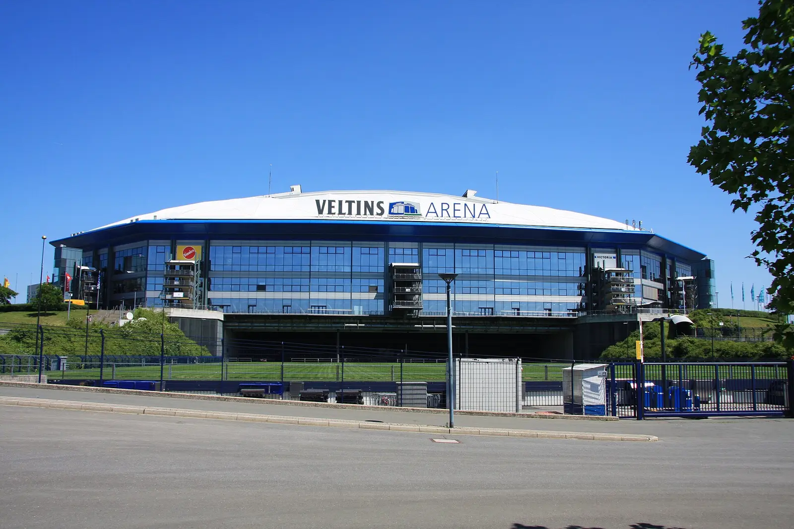 Glass facade of the Veltins-Arena in Gelsenkirchen under a blue sky