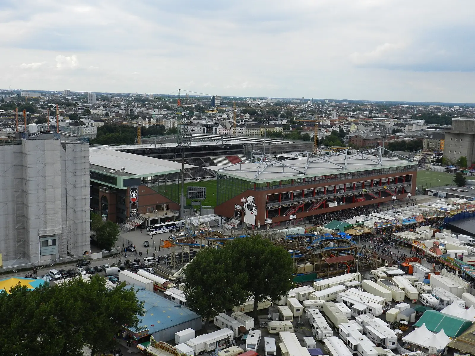 The Heiligengeistfeld fairground with stalls and a Ferris wheel seen from above