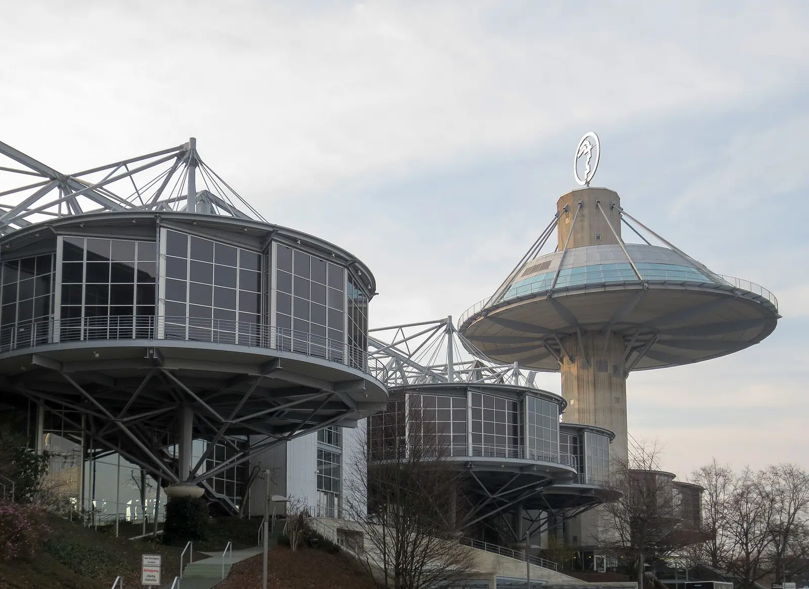 The Convention Center and tower of the Hannover exhibition grounds against an evening sky