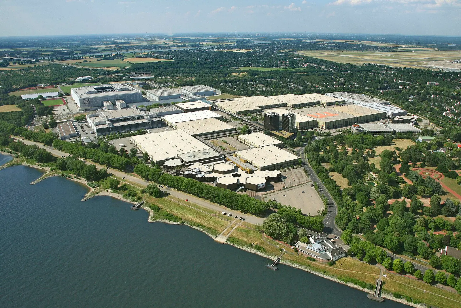 Aerial view of the Messe Düsseldorf exhibition grounds beside the Rhine